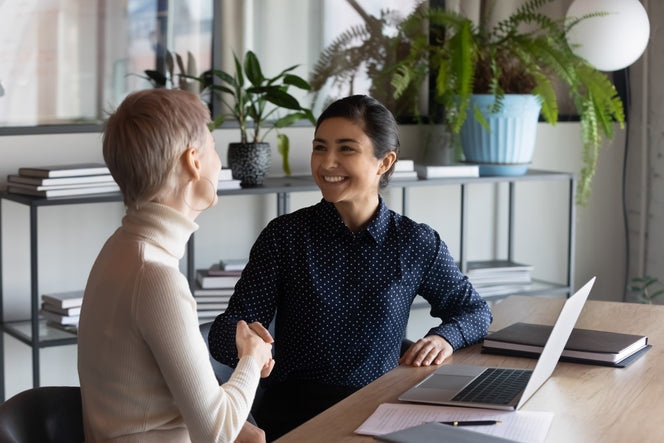 colleagues reaching out for a handshake