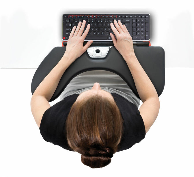 A woman seen from above sitting at her ergonomic mouse with arm rest support